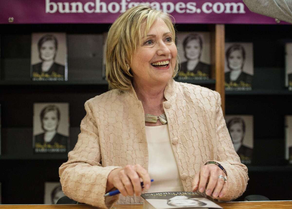 Former Secretary of State Hillary Rodham Clinton signs her book "Hard Choices" at a bookstore on Martha's Vineyard.