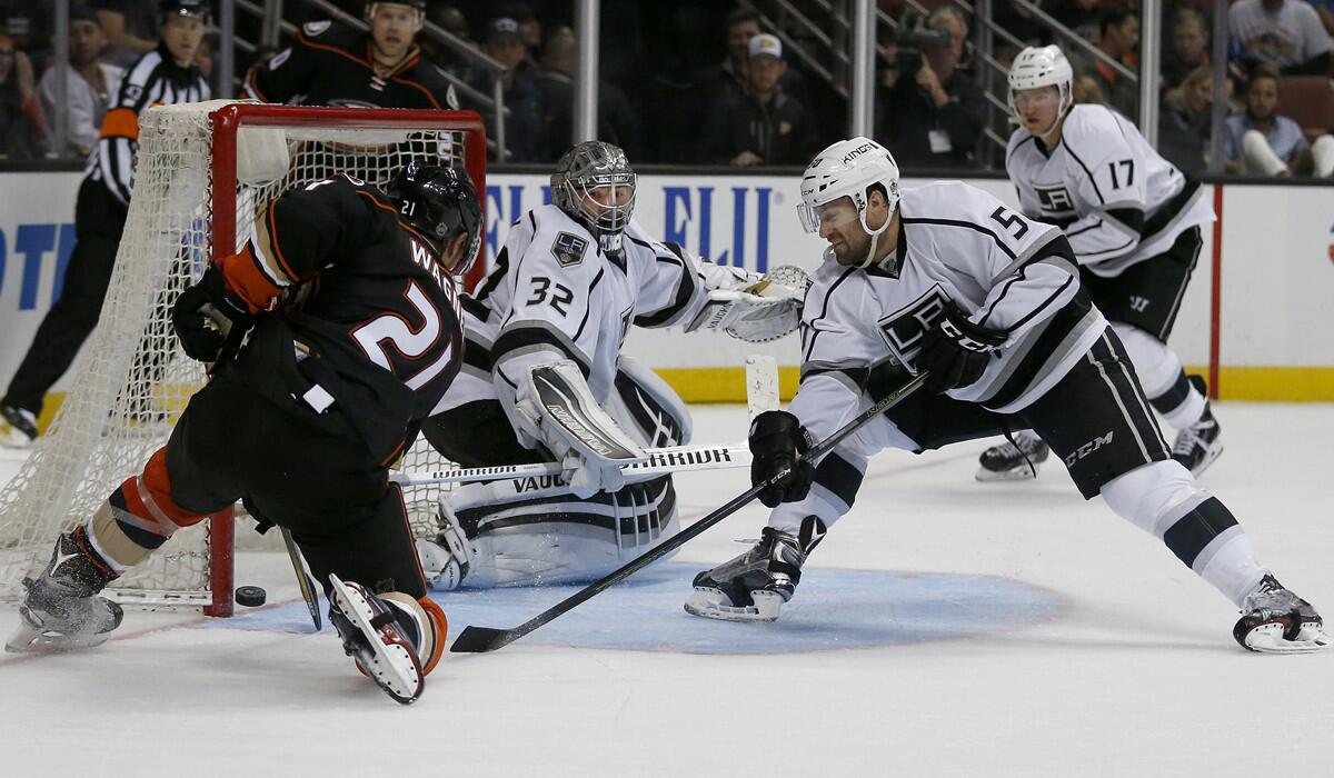 Kings goaltender Jonathan Quick, center, and defender Zach Trotman, right, defend the goal as Ducks center Chris Wagner comes close to scoring during the third period of an exhibition on Oct. 2.