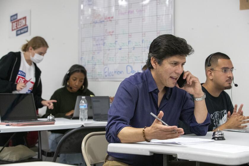 Los Angeles, CA - May 28: Mayoral candidate Kevin De Leon, second from right, talks on the phone with potential voters at his campaign headquarters on Saturday, May 28, 2022 in Los Angeles, CA. (Brian van der Brug / Los Angeles Times)