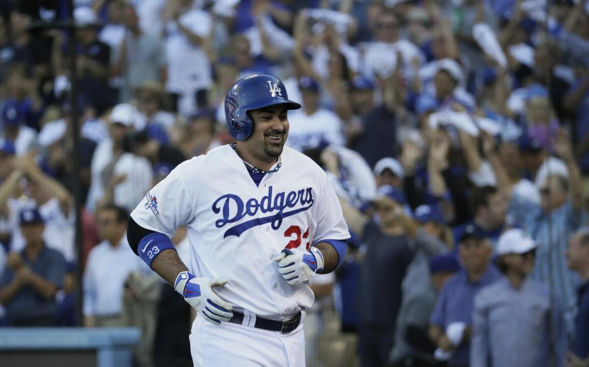Dodgers first baseman Adrian Gonzalez smiles after hitting a second home run during the Dodgers' win over the St. Louis Cardinals in Game 5 of the NLCS on Wednesday. The Dodgers are embracing their October run in unique fashion.