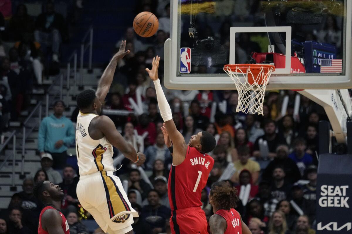 New Orleans Pelicans forward Zion Williamson (1) shoots over Houston Rockets forward Jabari Smith Jr. (1) in the second half of an NBA basketball game in New Orleans, Saturday, Nov. 12, 2022. The Pelicans won 119-106. (AP Photo/Gerald Herbert)