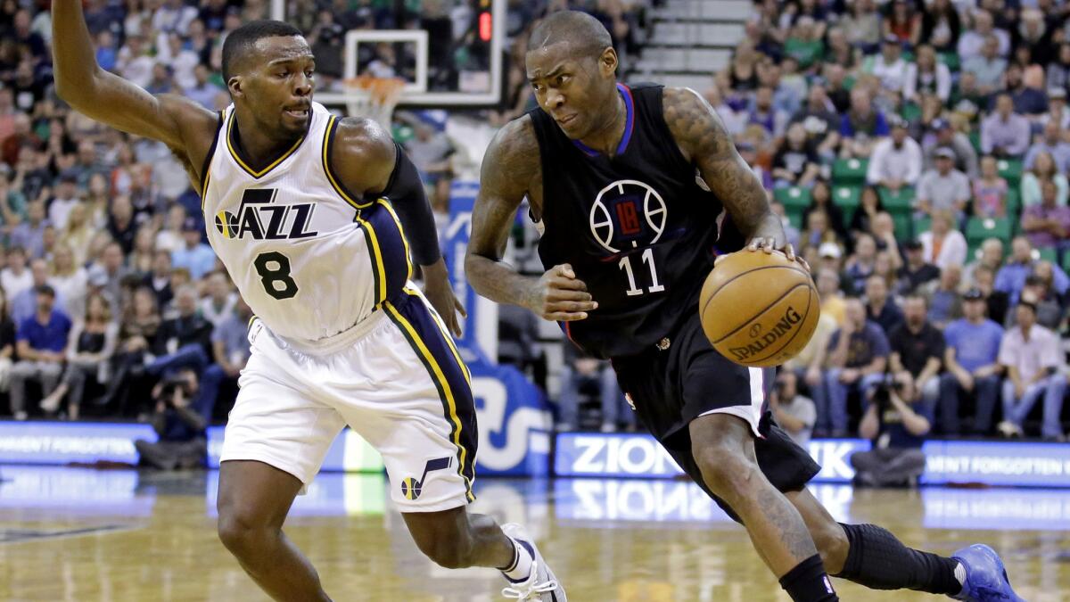 Clippers guard Jamal Crawford (11) drives around Jazz guard Shelvin Mack during the second half Friday.