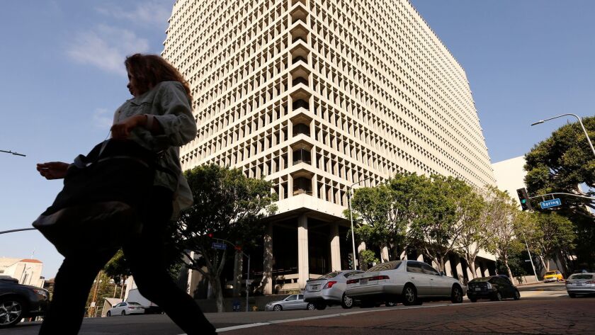 A woman walks in front of the Clara Shortridge Foltz Criminal Justice Center in downtown Los Angeles on May 18, 2017.