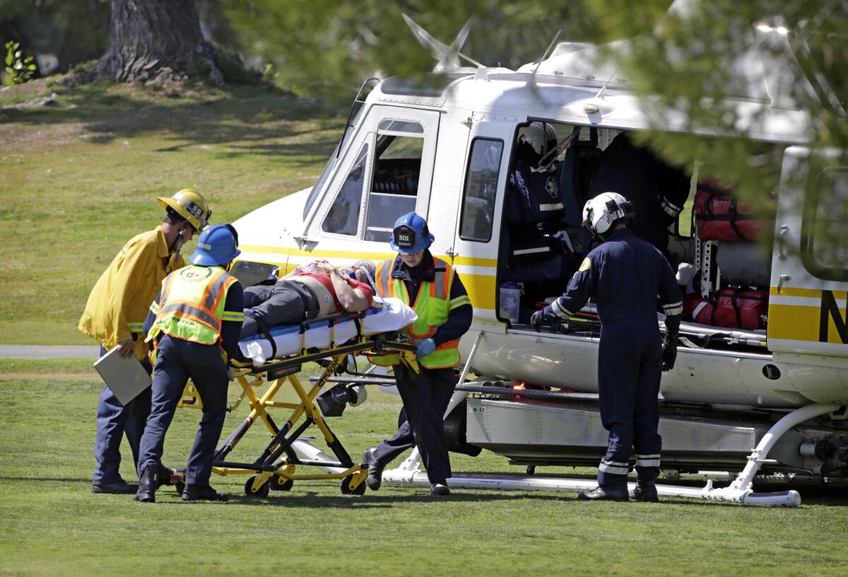 A victim is taken to a rescue helicopter on the Westlake Golf Course after a Cessna 172 emergency landed on the third fairway after a midair collision.