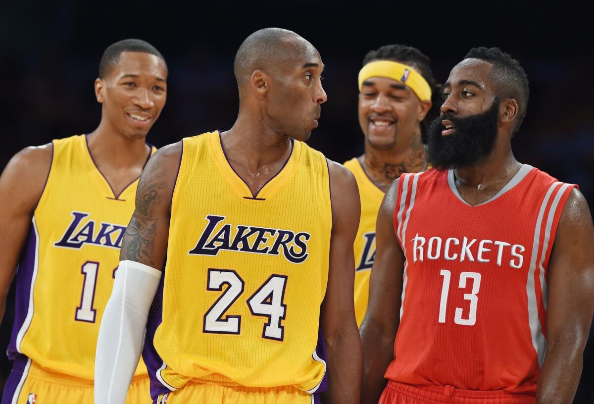 Wesley Johnson, left, Kobe Bryant and Jordan Hill talk with Houston's James Harden during a stoppage in play during the Lakers' season opener against the Rockets at Staples Center.