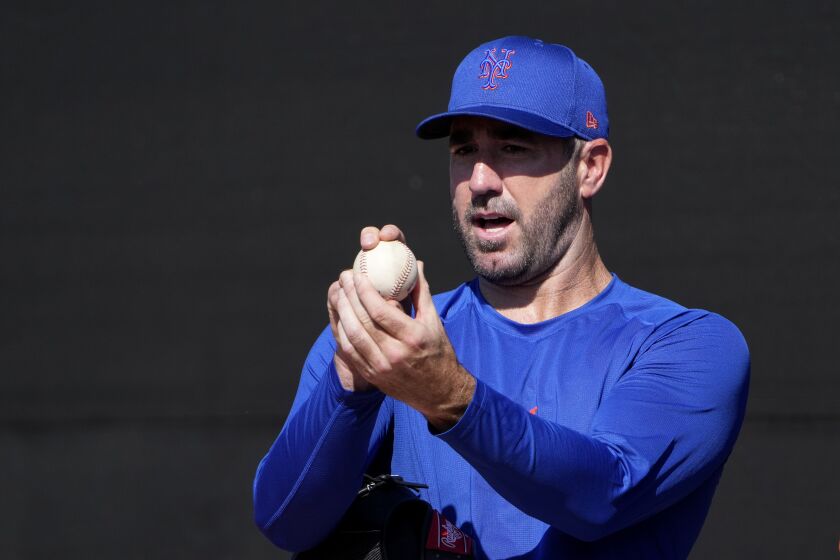 New York Mets pitcher Justin Verlander grips a ball during spring training baseball practice Monday, Feb. 20, 2023, in Port St. Lucie, Fla. (AP Photo/Jeff Roberson)
