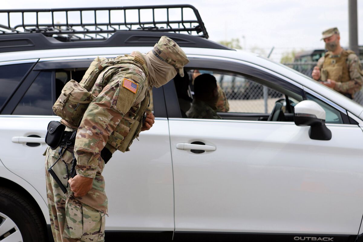 California State Guard Cpl. Nestor Ayson and his partner check a driver’s identification.