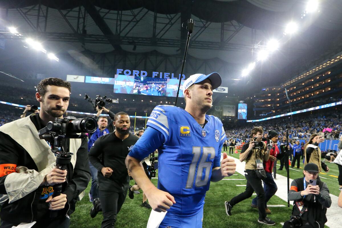 Detroit quarterback Jared Goff (16) walks off the field after the Lions defeated the Rams.