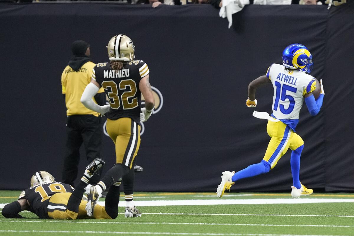 The Rams' Tutu Atwell (15) scores on a 62-yard touchdown catch ahead of Saints Tyrann Mathieu (32) and Chris Harris Jr.