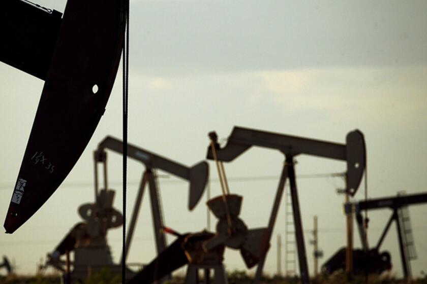 FILE - In this April 24, 2015 file photo, pumpjacks work in a field near Lovington, N.M. With more barrels of oil being pumped monthly from the Permian Basin, New Mexico is among the nation's top producing states. (AP Photo/Charlie Riedel, File)
