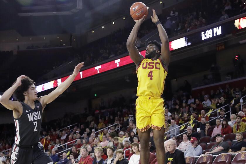Southern California's Daniel Utomi (4) shoots over Washington State's CJ Elleby (2) during the first half of an NCAA college basketball game Saturday, Feb. 15, 2020, in Los Angeles. (AP Photo/Marcio Jose Sanchez)
