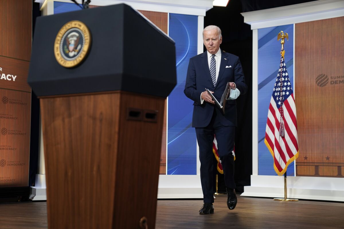 President Joe Biden arrives to deliver closing remarks to the virtual Summit for Democracy, in the South Court Auditorium on the White House campus, Friday, Dec. 10, 2021, in Washington. (AP Photo/Evan Vucci)