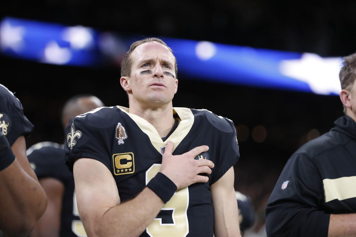 FILE - In this Dec. 23, 2018, file photo, New Orleans Saints quarterback Drew Brees (9) holds his hand to his heart during the national anthem before an NFL football game against the Pittsburgh Steelers in New Orleans. The 41-year-old Brees, who is the NFL's all-time leader in yards passing, completions and touchdowns, is entering his 20th NFL season and 15th with the New Orleans Saints. (AP Photo/Gerald Herbert, File)