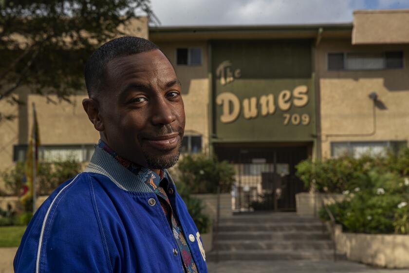 INGLEWOOD, CA - OCTOBER 11, 2021: Prentice Penny, who is the show runner for HBO's, "Insecure," is photographed in front of The Dunes apartment complex in Inglewood. The Dunes, a two-story, 52 unit complex built in 1961, serves as the exterior of Issa Rae's character on the show. (Mel Melcon / Los Angeles Times)