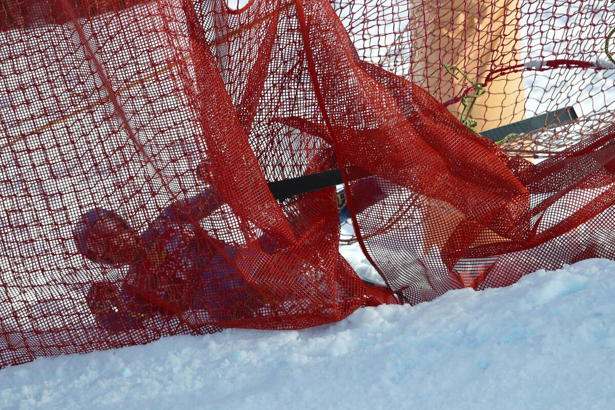 Skier Ryan Cochran-Siegle is entangled in safety netting.