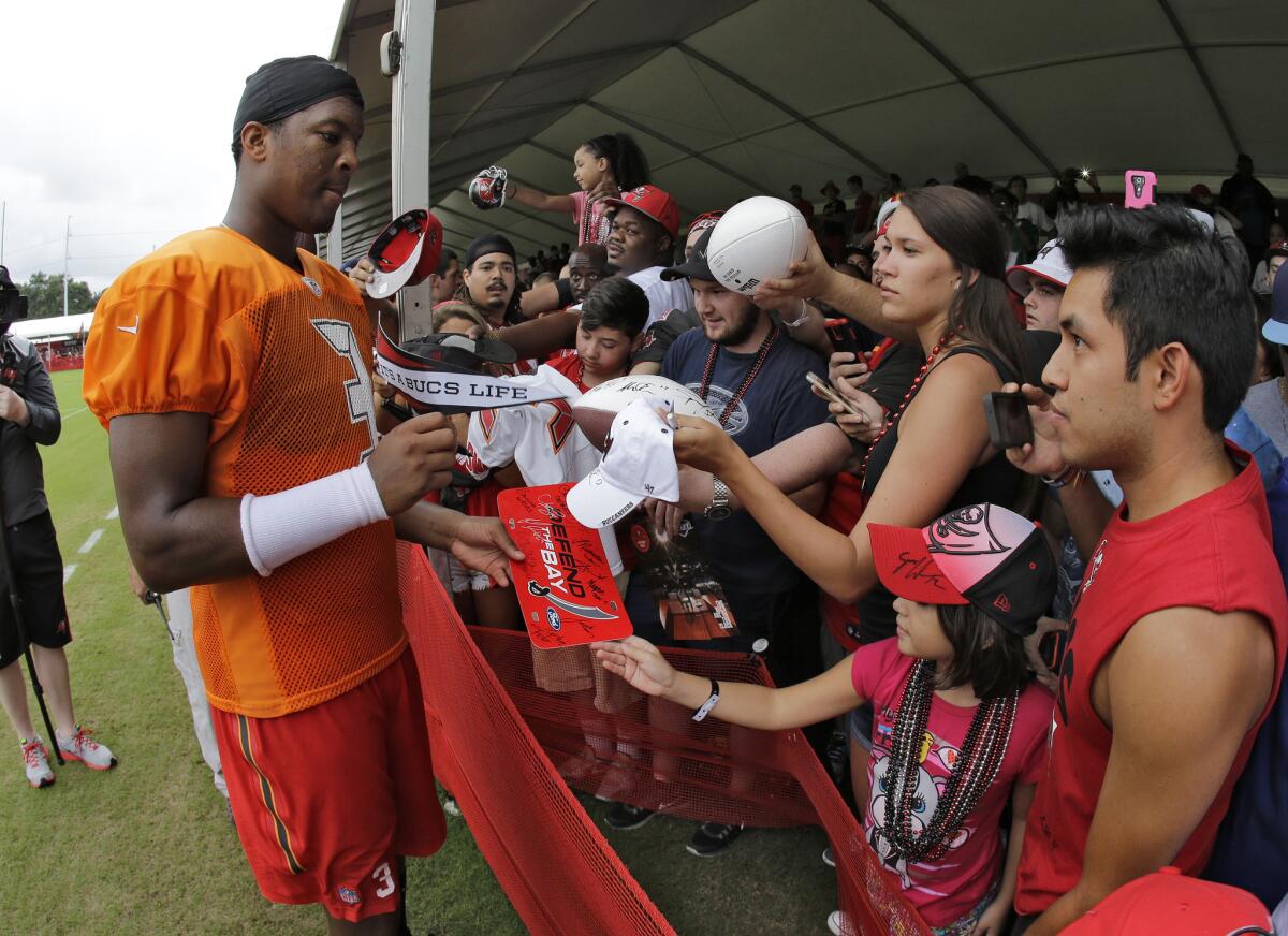 Tampa Bay quarterback Jameis Winston signs autographs for fans after a Buccaneers training camp practice on Aug. 2, 2015.