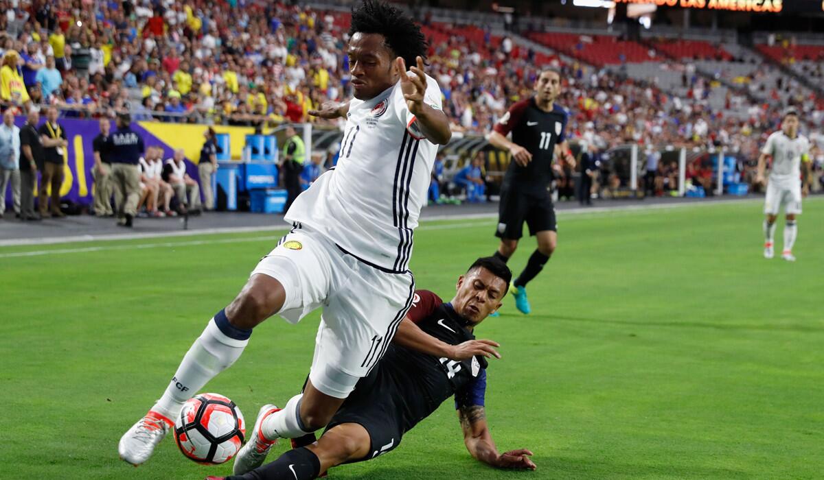 Juan Cuadrado, left, of Colombia is tackled by Michael Orozco of the U.S. during the first half of the Copa America Centenario third-place game.