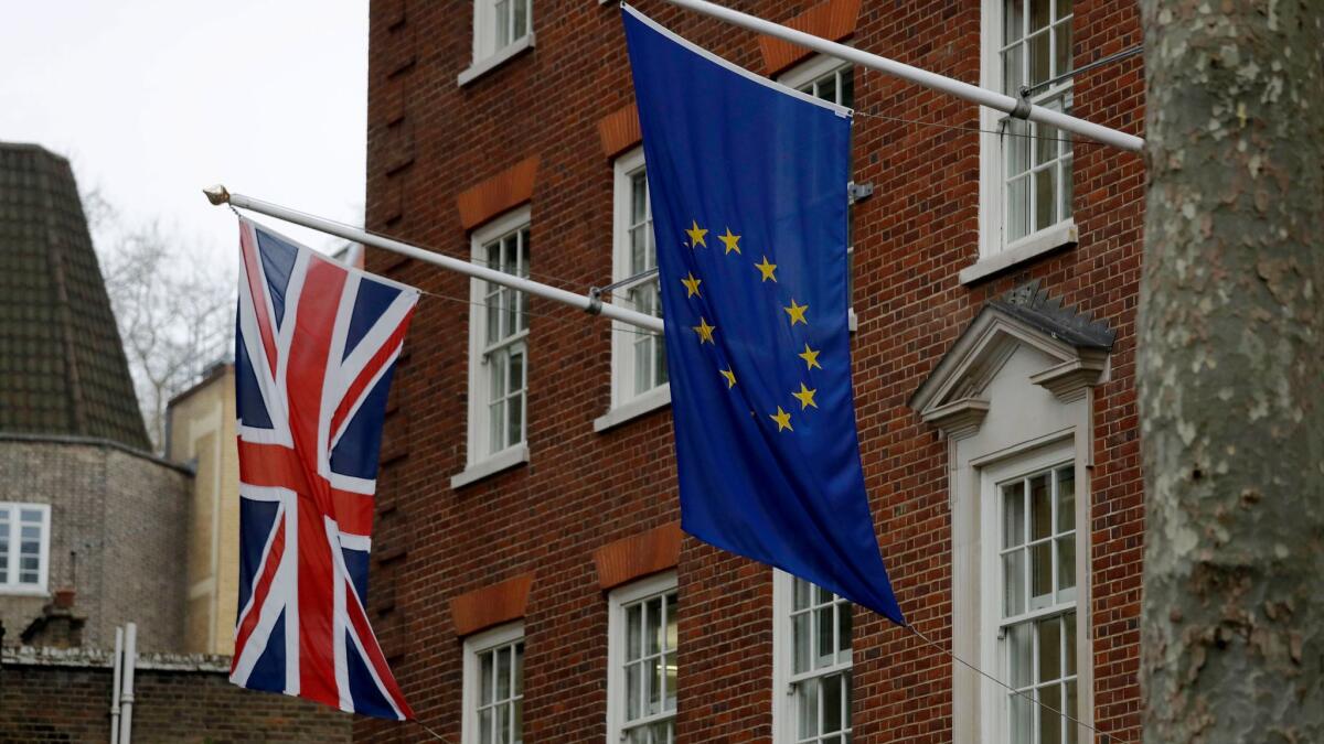 European and British Union flags hang outside Europe House, the European Parliament's offices in London, on March 20.