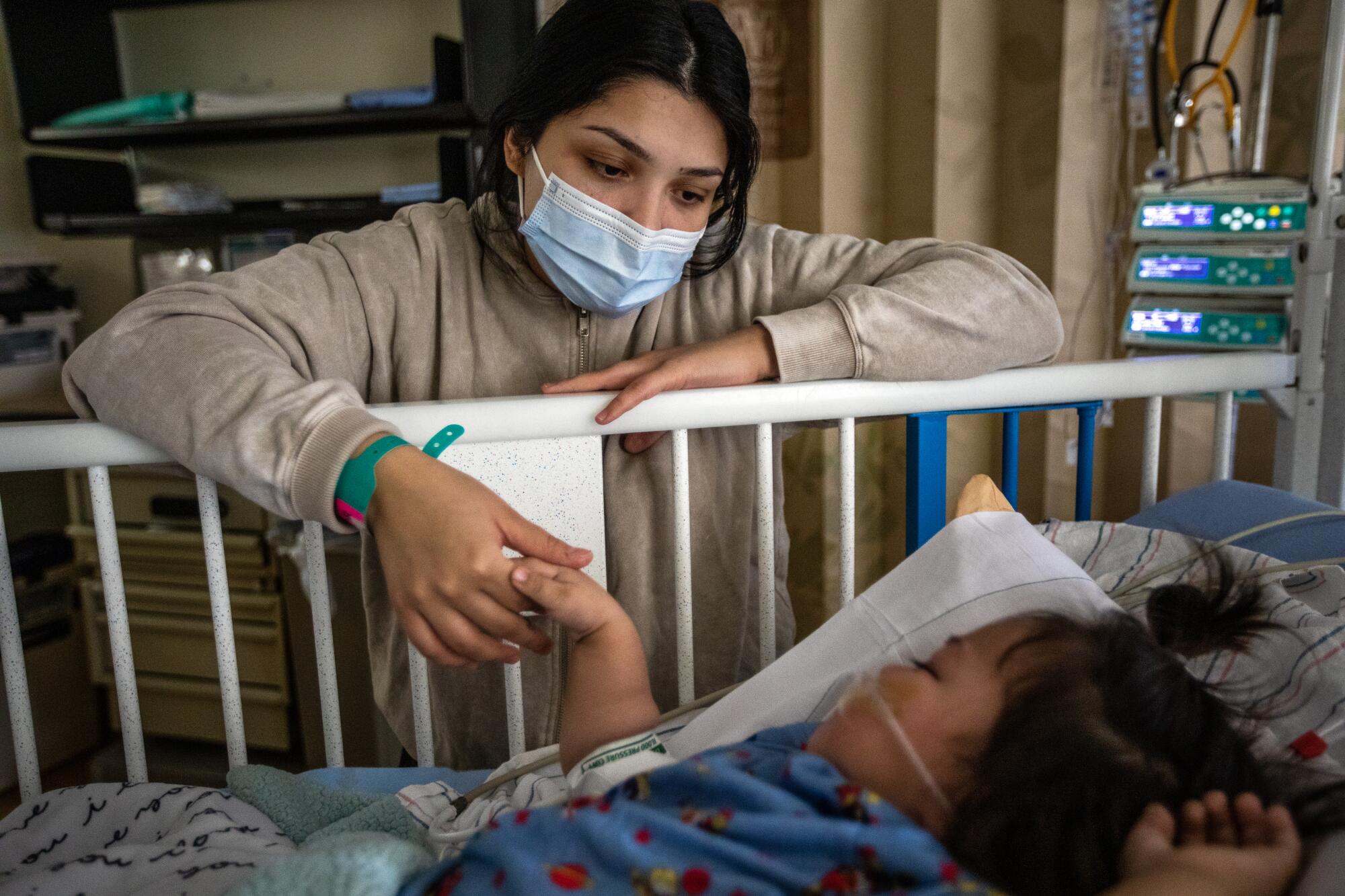 Priscilla Velazco keeps an eye on her 6-month-old daughter Emilia Zarazua, at Loma Linda University Children's Hospital 