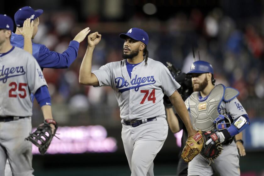 Los Angeles Dodgers relief pitcher Kenley Jansen (74) celebrates with teammates after defeating the Washington Nationals 10-4 during Game 3 of a baseball National League Division Series Sunday, Oct. 6, 2019, in Washington. (AP Photo/Julio Cortez)