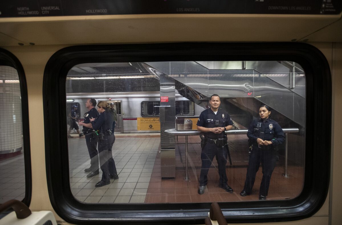Los Angeles Police Department officers stand guard at a downtown subway station in March.