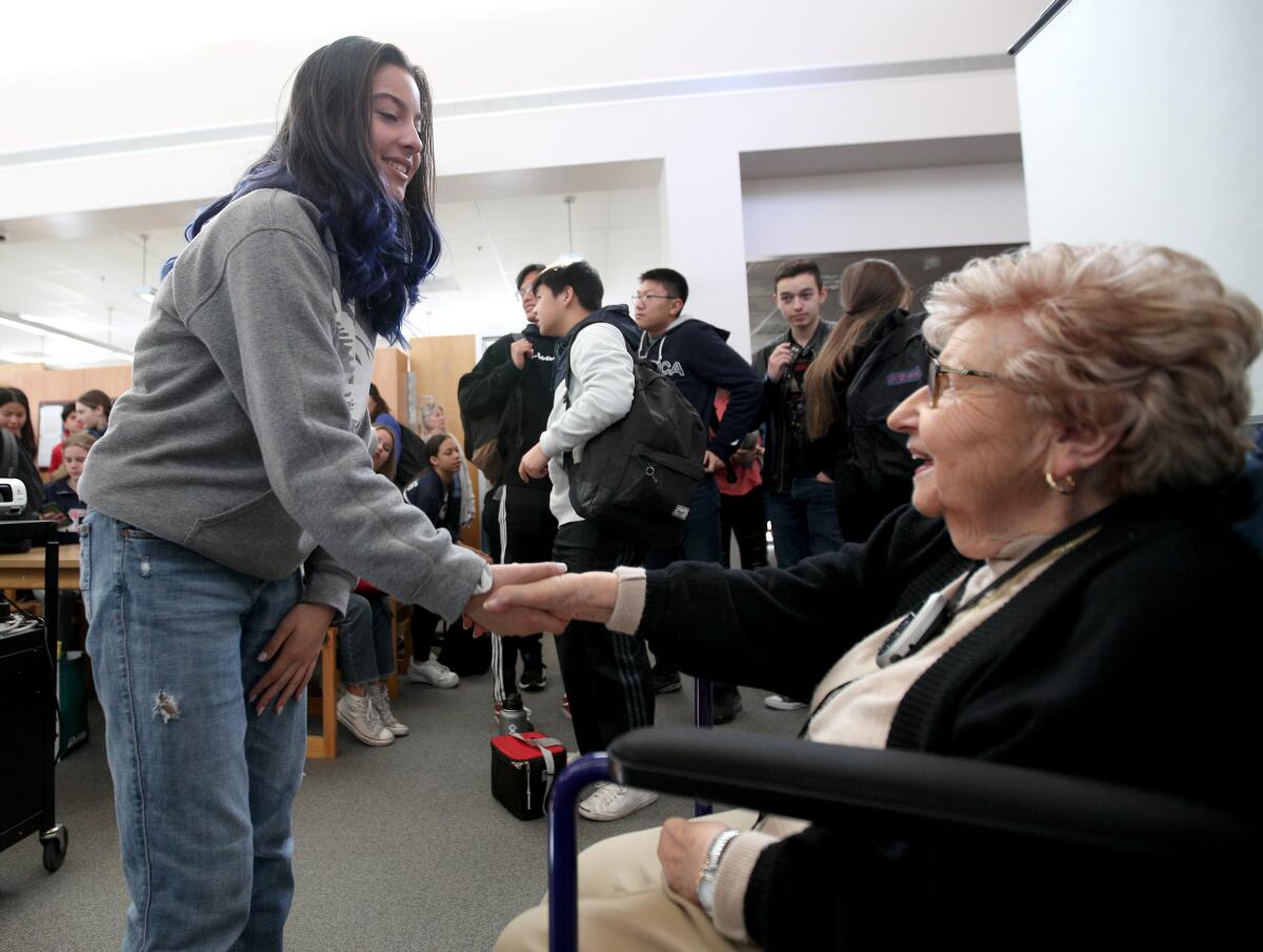 Holocaust survivor Edith Franke, 88, right, shakes hands with Crescenta Valley High School sophomore Dalia Del Castro after speaking about her ordeal of living in Nazi concentration camps during World War II.