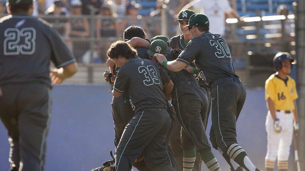 Sage Hill School's Brett Super (9), Toby Bush and Conner Hatz (33) celebrate beating Crean Lutheran, 9-0, in the CIF-SS Division 6 baseball championship game at UCR Sports Complex in Riverside on Saturday.