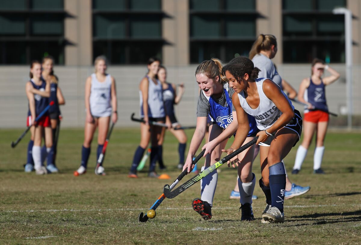 San Marcos High field hockey players Ella Maulden, left, and Maya Jackson do drills during a practice.