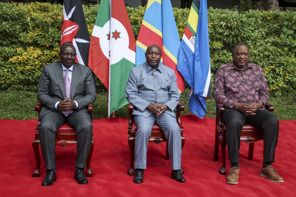 Kenya's President William Ruto, left, Burundi's President and summit chairperson Evariste Ndayishimiye, center, and Kenya's former President and summit facilitator Uhuru Kenyatta, right, pose for a group photograph ahead of the Third Inter-Congolese Consultations of the Nairobi Peace Process, the political track, Nairobi III, at a hotel in Nairobi, Kenya Monday, Nov. 28, 2022. The East African Community (EAC) led summit aims to find solutions to the ongoing armed conflict in Eastern Congo. (AP Photo/Brian Inganga)
