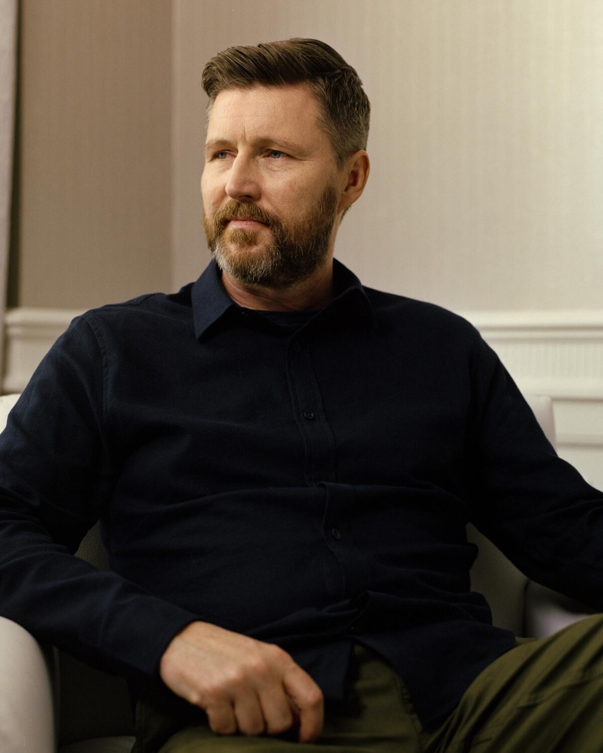 A portrait of Andrew Haigh wearing a dark sweater.