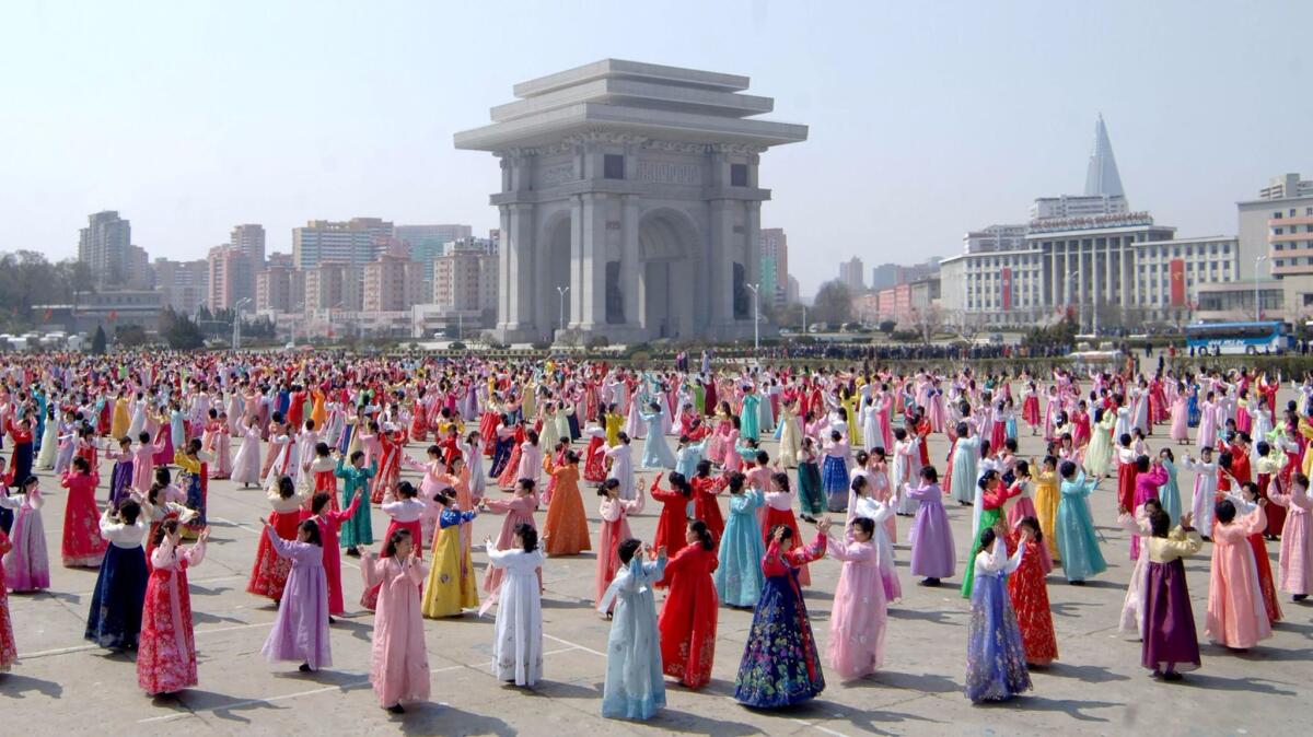 People dance to celebrate the fifth anniversary of Kim Jong Un's assumption of the top posts of the Workers' Party and the state in Pyongyang, North Korea, in a photo taken on April 11, 2017, and released on April 12 by North Korea's official Korean Central News Agency.