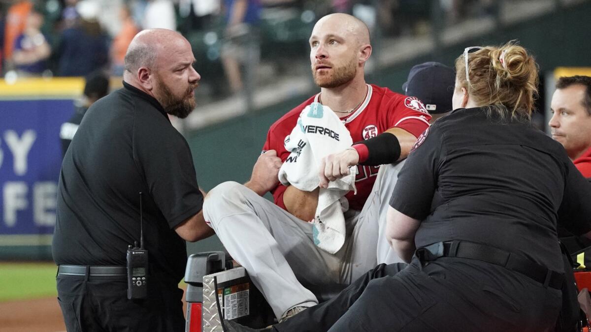 Angels catcher Jonathan Lucroy is carted off the field after Houston Astros baserunner Jake Marisnick collided with him at home plate July 7.