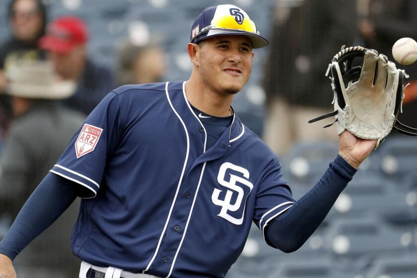 San Diego Padres' Manny Machado warms up prior to his first spring training baseball game of the season against the San Francisco Giants, Saturday, March 2, 2019, in Peoria, Ariz. (AP Photo/Matt York)
