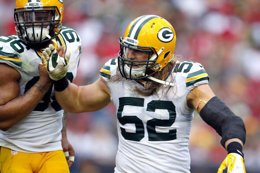 Packers linebacker Clay Matthews (52) is congratulated by teammate Julius Peppers after a sack against Tampa Bay on Dec. 21.