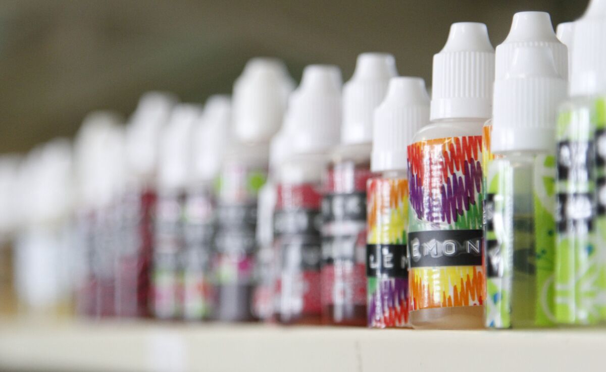 Flavoring for electronic cigarettes is displayed at a vaping shop. Medical groups warned the FDA that sweet and fruity flavors would lure young people into a nicotine addiction.