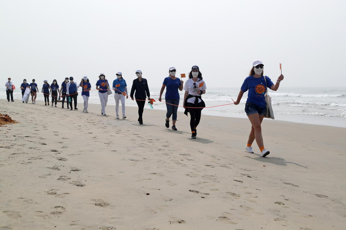 A group of 14 Patient Safety Movement Foundation members make their way to Newport Pier.