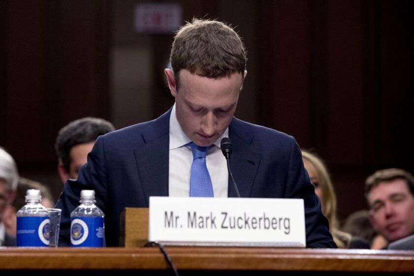 FILE - In this April 10, 2018, file photo Facebook CEO Mark Zuckerberg looks down as a break is called during his testimony before a joint hearing of the Commerce and Judiciary Committees on Capitol Hill in Washington. Twitter's ban on political advertising is ratcheting up the pressure on Facebook and Zuckerberg to follow suit. Zuckerberg doubled down on Facebooks approach in a call with analysts Wednesday, Oct. 30, 2019, he reiterated Facebooks stance that political speech is important." (AP Photo/Andrew Harnik, File)