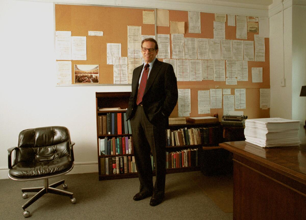 Robert A. Caro in his New York City office in 2002. On the wall behind him is an outline of the last chapter and at right is the typewriter he uses instead of a computer.