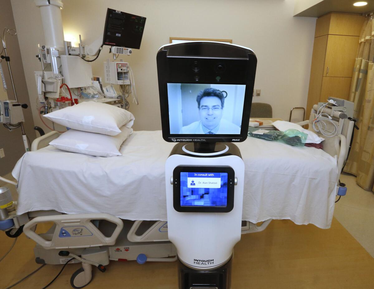 In this photo taken Wednesday, Nov. 6, 2013, Dr. Alan Shatzel, medical director of the Mercy Telehealth Network, is displayed on the monitor RP-VITA robot at Mercy San Juan Hospital in Carmichael, Calif. Telemedicine is a game changer, said Dr. Manuel Momjian, owner of Urgent 9 Urgent Care in Glendale, but it can’t always substitute an in-person visit.