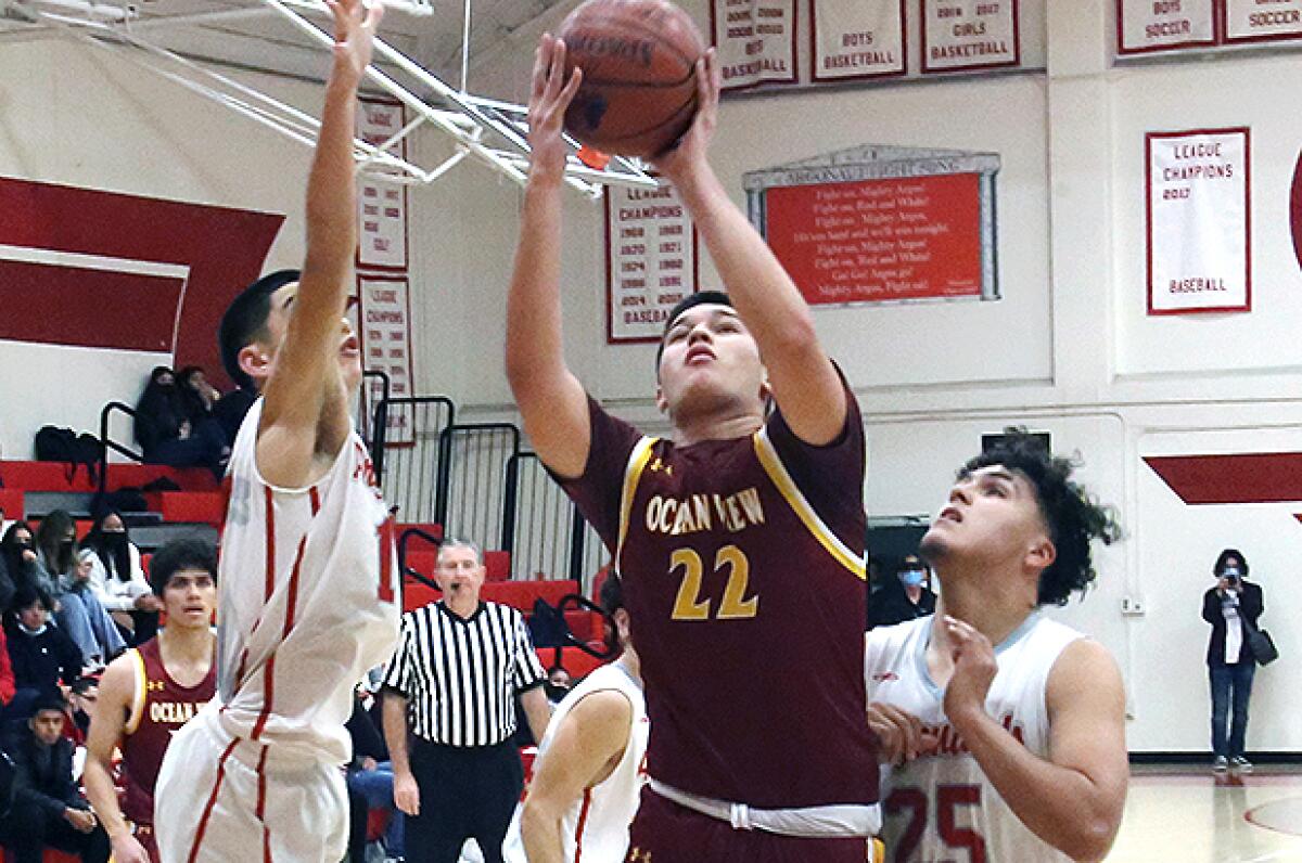 Ocean View’s Jeremiah Santiago (22) drives to the basket against Garden Grove