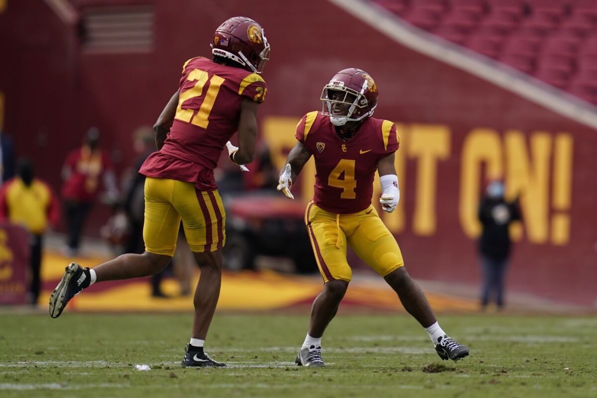 USC safeties Isaiah Pola-Mao (21) and Max Williams (4) celebrate after an incomplete pass against Arizona State.