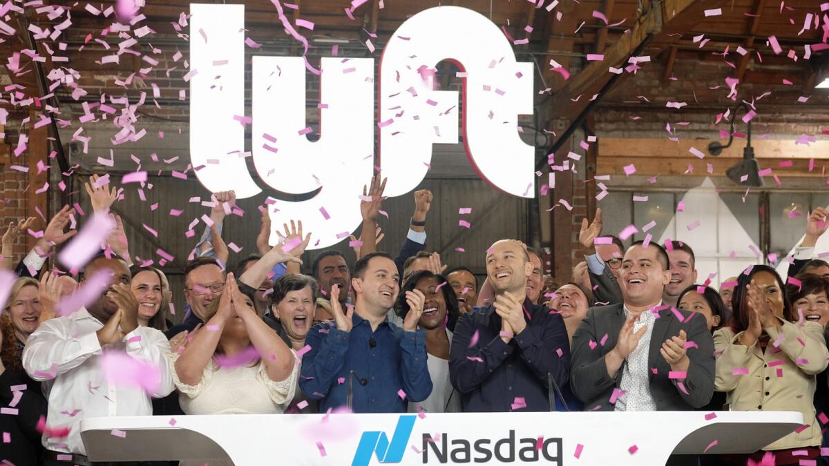 Lyft co-founders John Zimmer, center left, and Logan Green, center right, at Lyft's IPO event in Los Angeles.