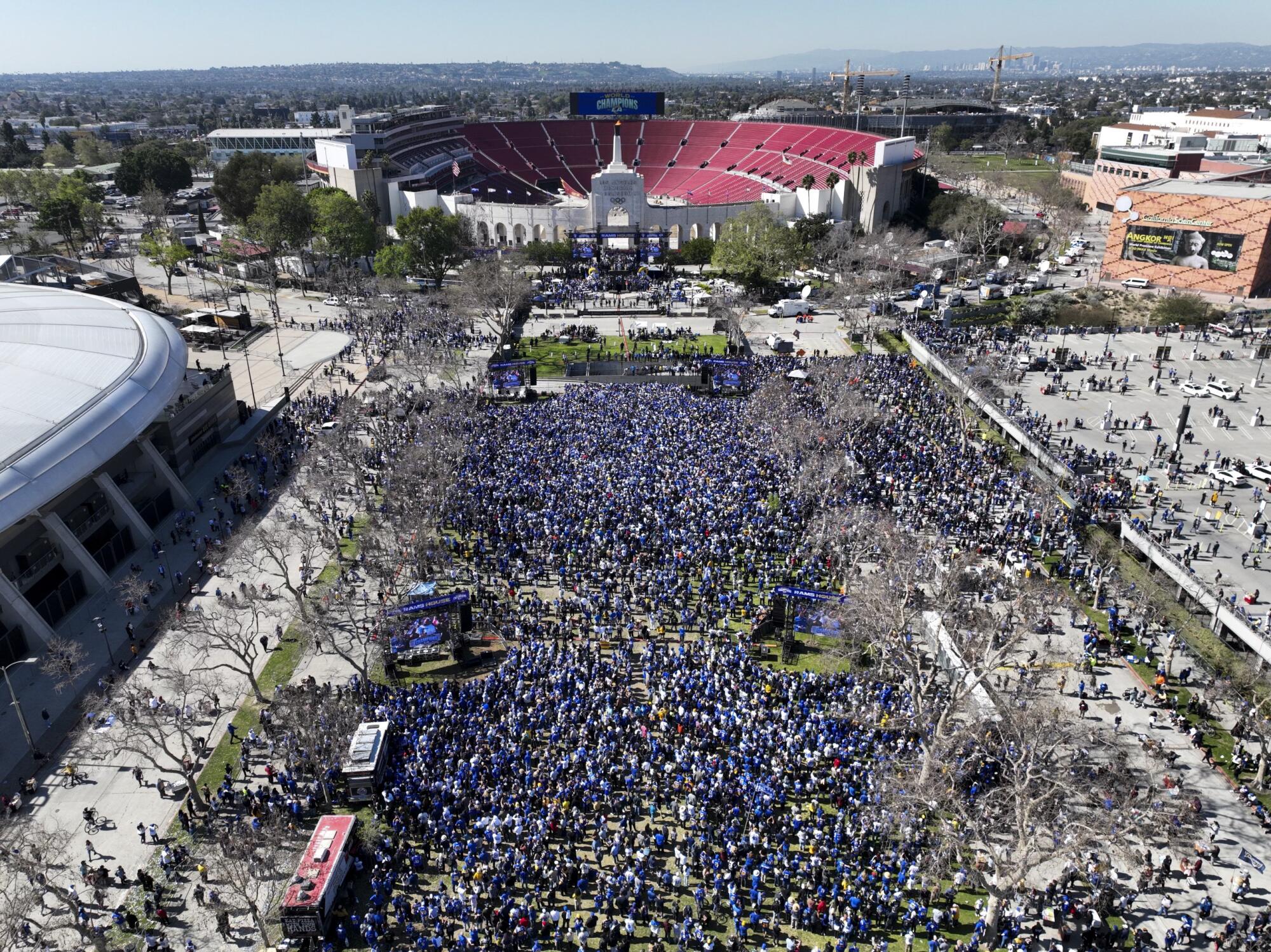 Fans gather on the lawn of Exposition Park to watch as the Los Angeles Rams celebrate their Super Bowl win