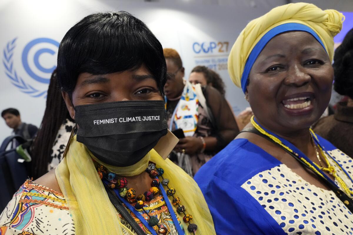 A woman wears a face mask that reads "feminist climate justice" at a session on women and gender constituency at the COP27 U.N. Climate Summit, Monday, Nov. 14, 2022, in Sharm el-Sheikh, Egypt. (AP Photo/Peter Dejong)