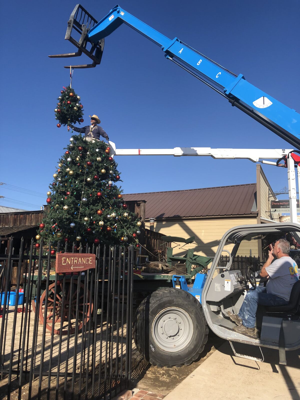 The last section of the Ramona Christmas tree is carefully lowered into place.