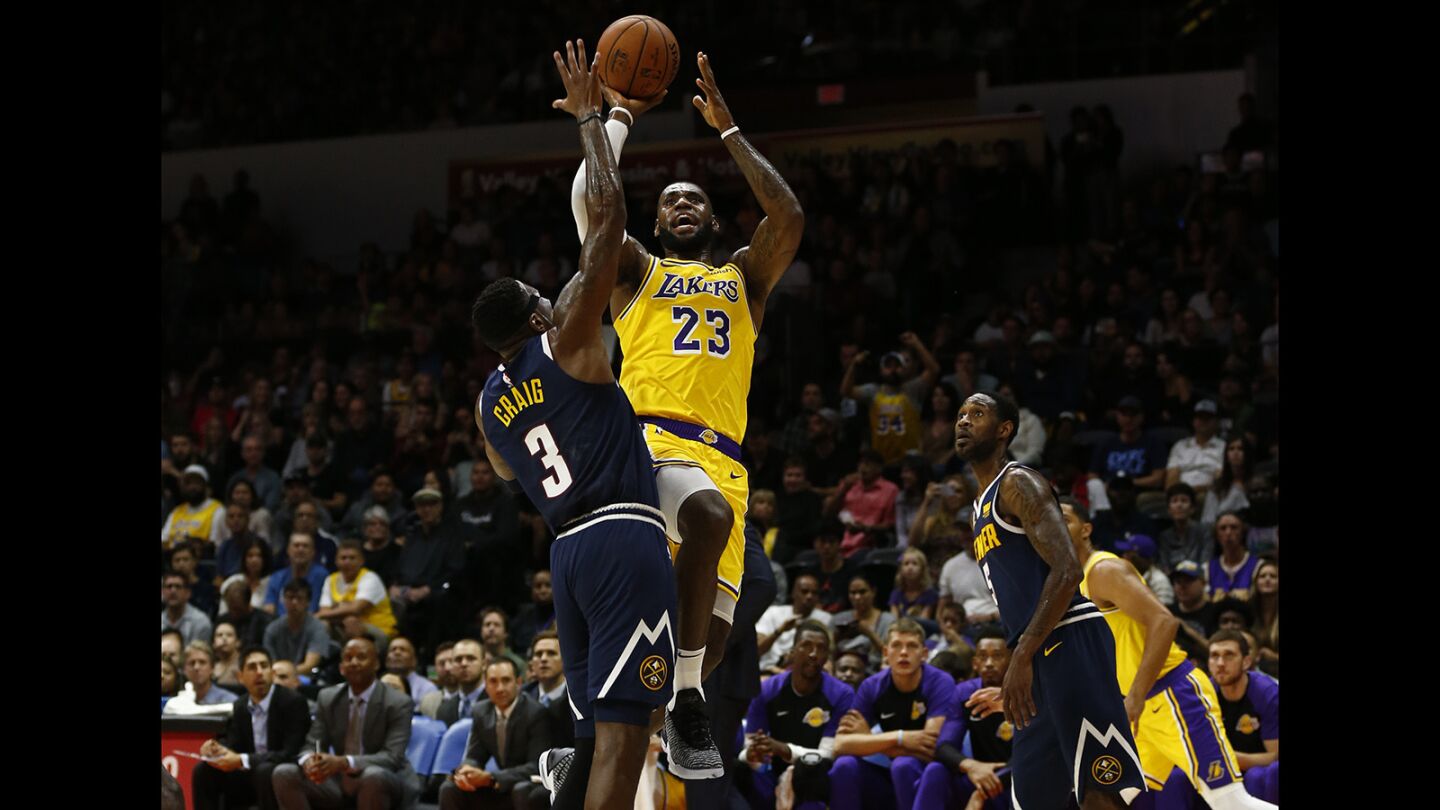 Los Angeles Lakers LeBron James (23) shoots over Denver Nuggets Torrey Craig in San Diego on Sunday, September 30, 2018. (Photo by K.C. Alfred/San Diego Union-Tribune)
