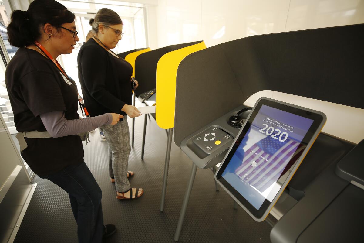 Maral Karaccusian, right, votes last week at a mobile vote center in Los Angeles' Grand Park.