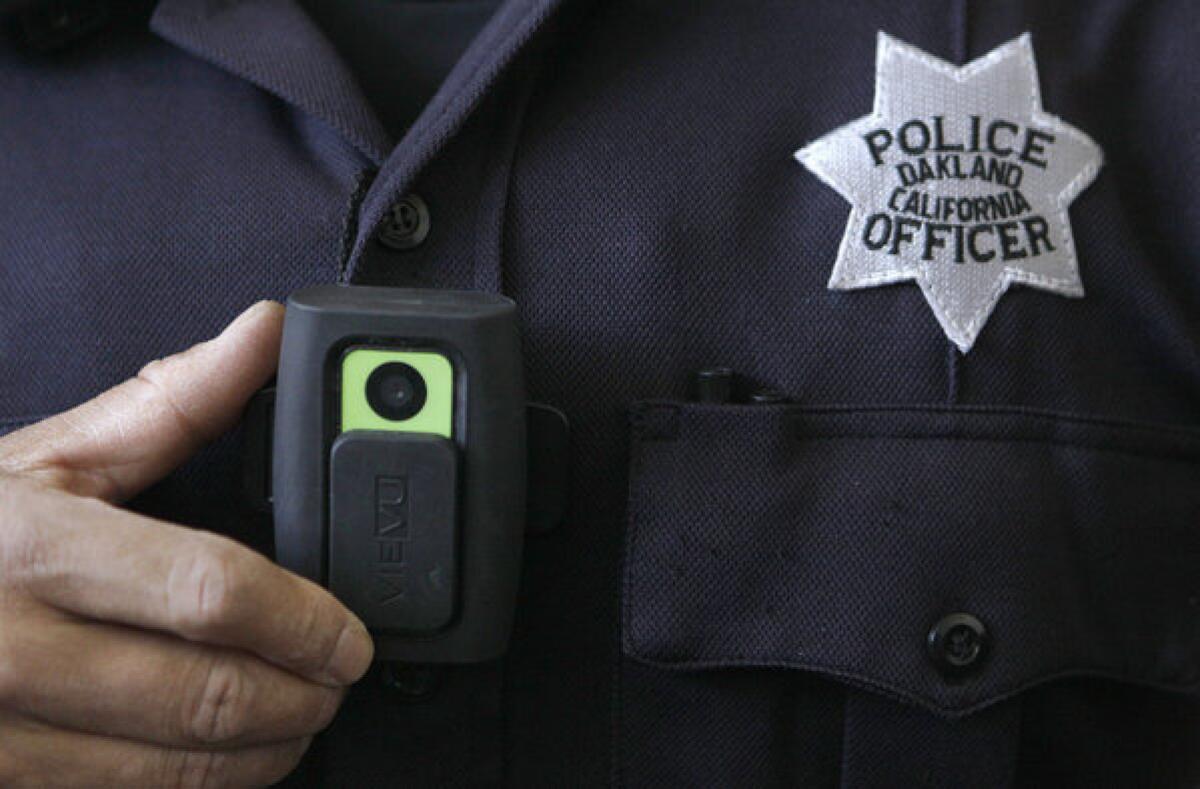 An Oakland police officer shows a video camera worn by some officers in that city. Steve Soboroff, president of the Los Angeles Police Commission, is pushing to outfit LAPD officers with on-body cameras.