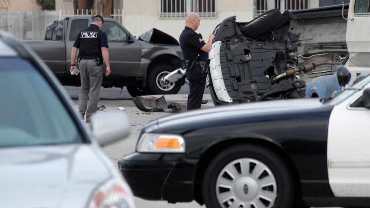 Police work the scene of a crash at 67th Street and Broadway in South L.A. after a car-to-car shooting and a subsequent chase.