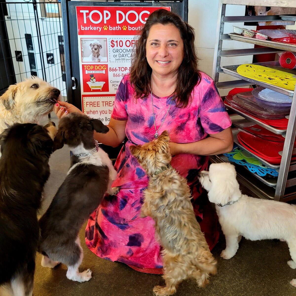 Karen Mahmalji, owner of TOP DOG in Huntington Beach, with dog customers.